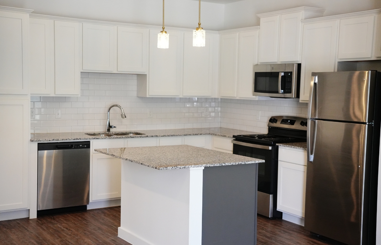 Kitchen interior with stainless steel appliances in The Leighton Apartments, Lubbock.