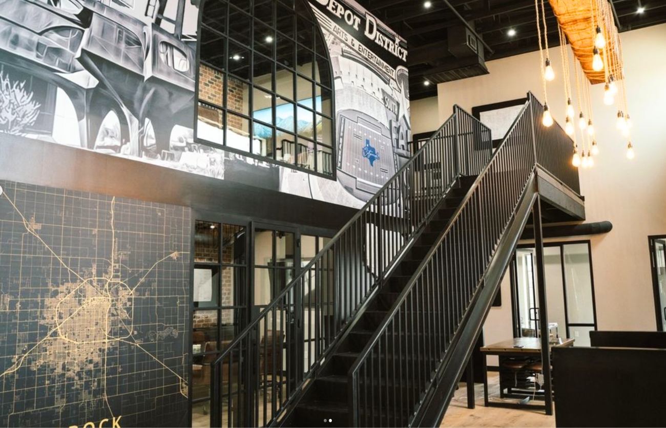 Modern interior of custom garden office with modern metal stairs and glass-front conference room.